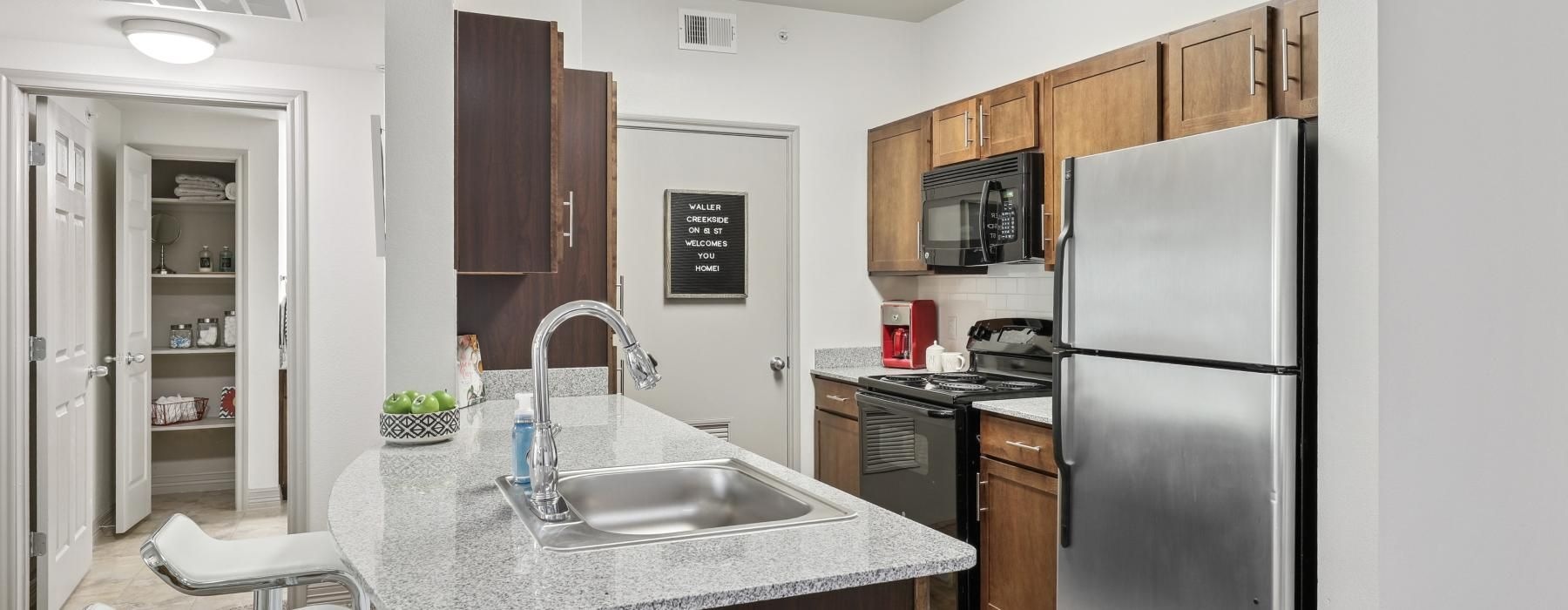 a kitchen with a sink and a refrigerator