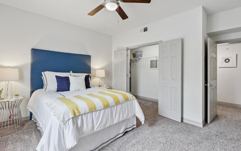 a bedroom with a bed and a fan