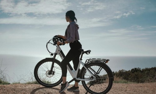 A beautiful community at the heart of all your passions a woman standing next to a bicycle