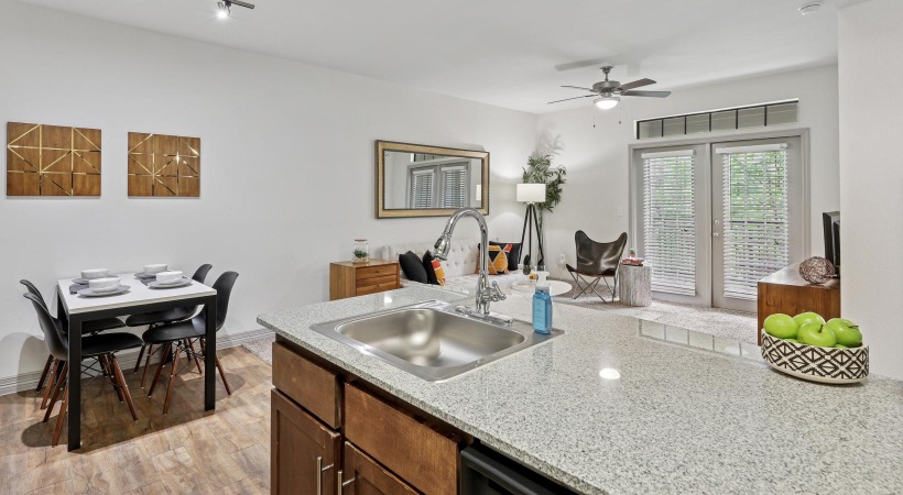 Wide open living areas flooded with natural light a kitchen with a sink and a dining table